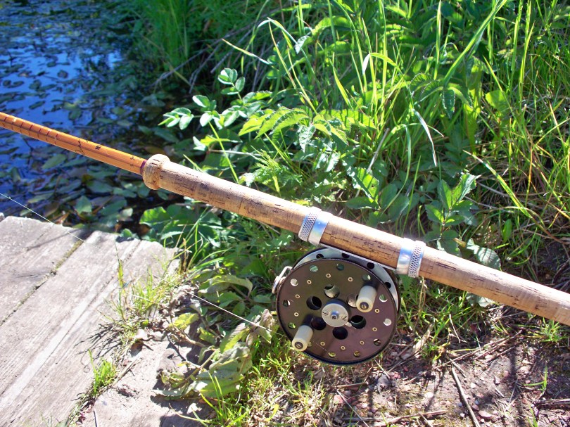 Picture of a Mark IV vintage split cane fishing rod with centre pin fishing reel