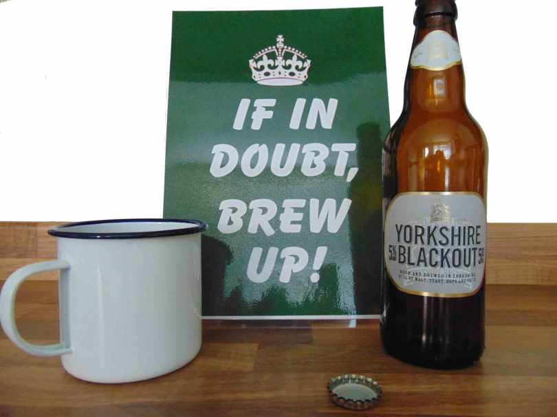 Picture of a sign that reads - If in doubt, brew up. Next to a mug of tea and a bottle of Yorkshire blackout ale