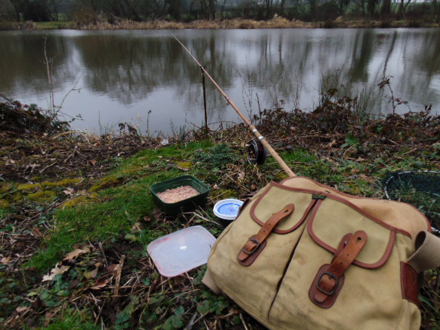 Picture of fishing rod in its rod rest with Brady bag and a box of maggots