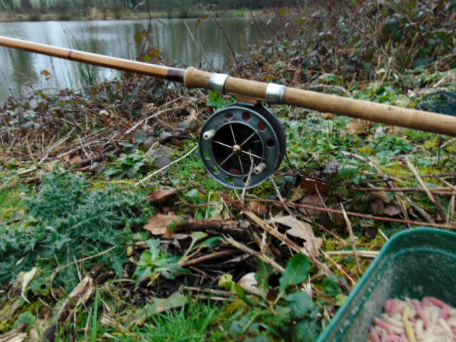 Picture of a Fred J Taylor fishing rod with Allcocks Aerial fishing reel sitting in a rod rest