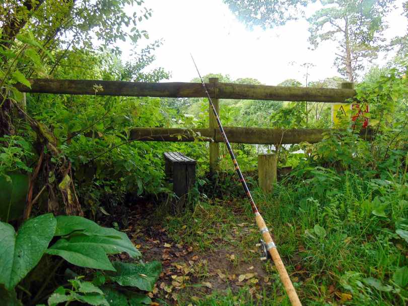 Picture of an R Sealey Match Winner cane fishing rod rest up against a wooden fence